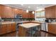 Bright kitchen features wood cabinets, an island with seating, and stainless steel appliances with ample counter space at 101 Magnolia Creek Dr, Canton, GA 30115
