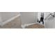 Carpeted stairs with white trim leading to the lower level, with view to bathroom at 101 Magnolia Creek Dr, Canton, GA 30115