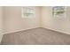 Bright bedroom featuring neutral carpeting and two windows letting in natural light at 2724 Quincy Ln, Decatur, GA 30034
