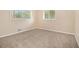 Cozy bedroom featuring neutral carpeting, two windows, and fresh paint at 2724 Quincy Ln, Decatur, GA 30034