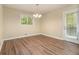 Inviting dining room featuring hardwood floors, a modern light fixture, and a door leading to the outside at 2724 Quincy Ln, Decatur, GA 30034