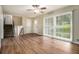 Bright living room with hardwood floors, ceiling fan, large windows offering serene views of the surrounding landscape at 2724 Quincy Ln, Decatur, GA 30034