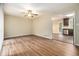 Spacious living room with hardwood floors and a ceiling fan open to the kitchen at 2724 Quincy Ln, Decatur, GA 30034