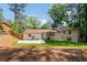 An exterior view of the backyard with a grassy area and a patio at 3456 Thornewood Dr, Atlanta, GA 30340
