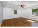 This bedroom boasts hardwood floors, two windows and a modern ceiling fan at 3456 Thornewood Dr, Atlanta, GA 30340