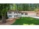Charming split-level home featuring a manicured lawn, white siding, brown trim, and a two-car garage at 3456 Thornewood Dr, Atlanta, GA 30340