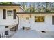 Close-up of front entrance with white door, decorative lights, and landscaping at 3456 Thornewood Dr, Atlanta, GA 30340