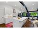 Modern kitchen with white cabinetry, stainless appliances, a spacious island, and an adjacent dining area at 3456 Thornewood Dr, Atlanta, GA 30340