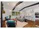 Open-concept living space showcasing a fireplace, hardwood floors, and modern kitchen at 3456 Thornewood Dr, Atlanta, GA 30340