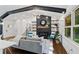 Open living room with hardwood floors, beamed ceiling, modern furniture, and large windows at 3456 Thornewood Dr, Atlanta, GA 30340