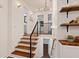 Elegant staircase with hardwood steps, modern railings, and contemporary lighting at 3456 Thornewood Dr, Atlanta, GA 30340