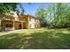 Spacious backyard featuring a deck, hot tub, mature trees, and plenty of room for outdoor activities at 3460 Highgate Hills Ne Dr, Duluth, GA 30097