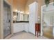 Bright bathroom featuring a glass door shower, white cabinets, granite counters, and neutral tile flooring at 3460 Highgate Hills Ne Dr, Duluth, GA 30097