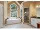 Bathroom featuring a soaking tub, glass shower, and lots of light at 3460 Highgate Hills Ne Dr, Duluth, GA 30097