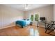 Bedroom with hardwood floors, neutral walls, a ceiling fan, and a window providing natural light at 3460 Highgate Hills Ne Dr, Duluth, GA 30097