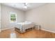 Bedroom with hardwood floors, neutral walls, a ceiling fan, and a window providing natural light at 3460 Highgate Hills Ne Dr, Duluth, GA 30097