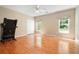 Spacious bedroom with hardwood floors, natural light, and a ceiling fan, perfect for a relaxing retreat at 3460 Highgate Hills Ne Dr, Duluth, GA 30097