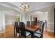 Elegant dining room with hardwood floors, chandelier, and classic architectural details and trim at 3460 Highgate Hills Ne Dr, Duluth, GA 30097