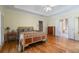 Spacious main bedroom featuring hardwood floors, a tray ceiling, and access to the ensuite bathroom at 3460 Highgate Hills Ne Dr, Duluth, GA 30097