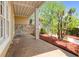 Open side porch with stone flooring, stone accent wall and beautiful view of the landscaped yard at 3460 Highgate Hills Ne Dr, Duluth, GA 30097