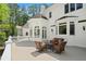 Beautiful white house and patio with outdoor seating and a lush green lawn at 4340 Candacraig, Johns Creek, GA 30022