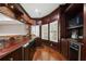 Wet bar with wood paneling, built in shelves, and updated appliances at 4340 Candacraig, Johns Creek, GA 30022