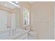 Charming bathroom features patterned wallpaper, a skylight, and classic white fixtures at 4340 Candacraig, Johns Creek, GA 30022