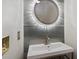 A modern bathroom featuring a sleek vanity, illuminated mirror, and stylish fixtures at 4340 Candacraig, Johns Creek, GA 30022