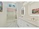 Modern bathroom features a double vanity, sleek lighting, and glass-enclosed shower at 4340 Candacraig, Johns Creek, GA 30022