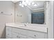 Bathroom with white cabinetry, spacious countertop, decorative mirror lighting, and glass shower with gray tile at 4340 Candacraig, Johns Creek, GA 30022