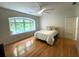 Bright bedroom with hardwood floors, large window, and ceiling fan at 4340 Candacraig, Johns Creek, GA 30022