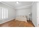 Bright bedroom with hardwood floors, white walls, window with shutters, and a comfortable sofa-style bed at 4340 Candacraig, Johns Creek, GA 30022