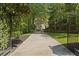 Gated driveway entrance lined with mature trees leading to an elegant home at 4340 Candacraig, Johns Creek, GA 30022