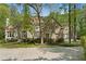 Charming stone home with manicured landscaping and a circular driveway nestled in a wooded setting at 4340 Candacraig, Johns Creek, GA 30022