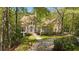 Charming two-story home with brick and stone exterior, lush landscaping, and a curved driveway at 4340 Candacraig, Johns Creek, GA 30022