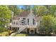 Back of house features balcony with white rails, manicured lawn and mature trees at 4340 Candacraig, Johns Creek, GA 30022