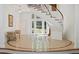 Spacious foyer with a winding staircase, tile flooring, and views of the front yard through glass doors at 4340 Candacraig, Johns Creek, GA 30022