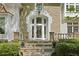 Elegant front entrance with stone steps, lion statues, and a decorative glass door at 4340 Candacraig, Johns Creek, GA 30022