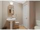 Bathroom features pedestal sink, neutral color scheme, and classic fixtures at 4340 Candacraig, Johns Creek, GA 30022