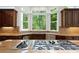 Bright kitchen featuring granite countertops and stainless appliances with view of wooded backyard at 4340 Candacraig, Johns Creek, GA 30022