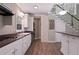 Kitchen with stainless steel appliances, white cabinets, wood countertops and staircase to upper level at 4340 Candacraig, Johns Creek, GA 30022