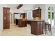 A gourmet kitchen featuring custom cabinetry, stone floors, an island, and lots of counter space at 4340 Candacraig, Johns Creek, GA 30022
