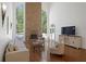 Bright living room with stone fireplace, hardwood floors, and large windows with views of the backyard at 4340 Candacraig, Johns Creek, GA 30022