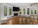 A secondary living room with a fireplace, lots of windows, and a sliding mirror door closet at 4340 Candacraig, Johns Creek, GA 30022