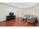 Bright living room with hardwood floors, neutral paint, and comfortable gray sofa at 4340 Candacraig, Johns Creek, GA 30022