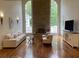 Living room with high ceilings, fireplace, hardwood floors and tall windows at 4340 Candacraig, Johns Creek, GA 30022