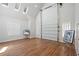 Bright living area with high ceilings, shuttered windows, wood flooring, and a roll-up garage door at 4340 Candacraig, Johns Creek, GA 30022