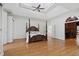 Spacious main bedroom with tray ceiling, a king bed, and access to additional living space at 4340 Candacraig, Johns Creek, GA 30022