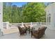 Spacious outdoor patio with ample seating and views of the lush backyard and surrounding trees at 4340 Candacraig, Johns Creek, GA 30022