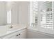 Charming powder room features white vanity, a window with shutters, and neutral decor at 4340 Candacraig, Johns Creek, GA 30022
